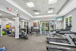 Levittown apartment for rent - A gym with treadmills, exercise equipment, and a green exercise ball.