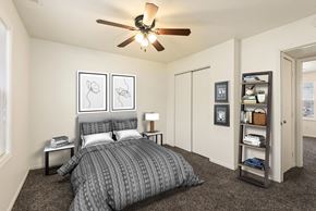 Tonganoxie apartment for rent - a bedroom with a bed and a ceiling fan