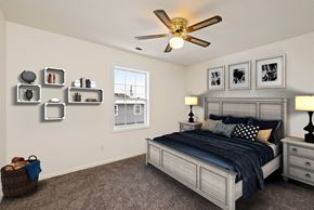 Tonganoxie apartment for rent - a bedroom with a bed and a ceiling fan