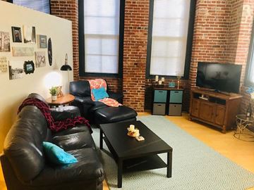 St. Louis apartment for rent - a living room with leather furniture and a television