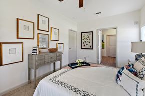 San Marcos apartment for rent - a bedroom with a bed and a dresser with pictures on the wall