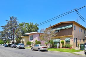 Downey apartment for rent - A row of houses with cars parked in front.