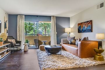 Norwalk apartment for rent - A living room with a brown couch and a white rug.