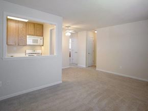 Passaic apartment for rent - kitchen with white appliances and wooden cabinets.