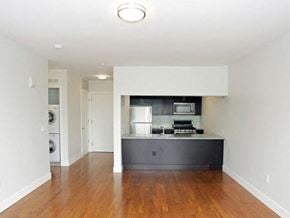 Montclair apartment for rent - an empty living room and kitchen with a wood floor