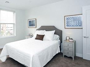 Montclair apartment for rent - a white bedroom with a bed and a night stand