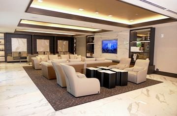Coral Gables apartment for rent - a large living room with white furniture and a television