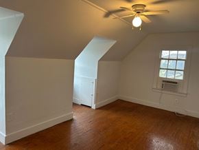 Talladega apartment for rent - A room with a ceiling fan and a window with an air conditioner unit.