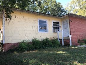 Talladega apartment for rent - A small house with a white door and a window with a white frame.