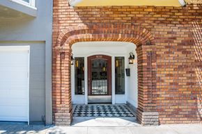San Francisco apartment for rent - A red brick house with a white door and a black and white checkered floor.