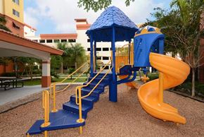 Miami apartment for rent - a playground with a blue and yellow swing set
