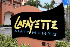 Miami apartment for rent - a black and yellow sign with the name of a apartment building