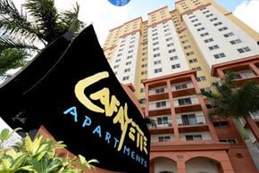 Miami apartment for rent - a black flag in front of a tall building