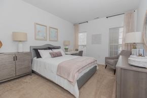 Moon apartment for rent - a bedroom with a bed and a dresser and a window