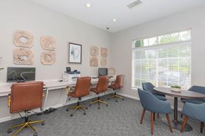 Moon apartment for rent - a conference room with desks and chairs and a window
