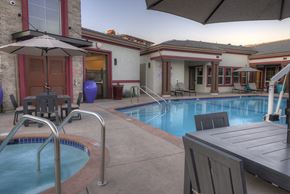 American Canyon apartment for rent - Pet-Friendly Apartments in American Canyon, CA - The Village at Vintage Ranch - Pool with Jacuzzi, Lounge Chairs, and Umbrella Tables
