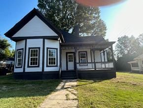 Talladega house for rent - a white house with a porch and a sidewalk