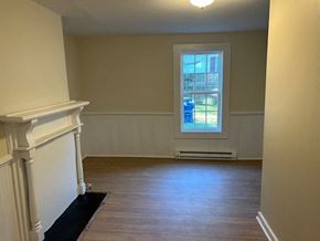 Talladega house for rent - an empty living room with a window and wooden floors
