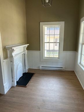 Talladega house for rent - a empty room with a fireplace and a window