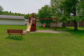 Gouverneur apartment for rent - a playground with a swing set and a bench in a yard