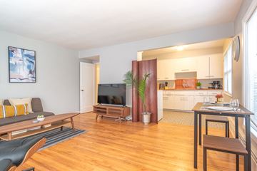 Portland apartment for rent - a living room with a couch and a table and a television
