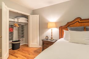 Portland apartment for rent - a bedroom with a bed and a closet with shelves