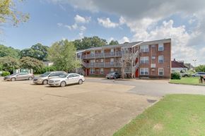 Norfolk apartment for rent - a large brick apartment building with cars parked in a parking lot
