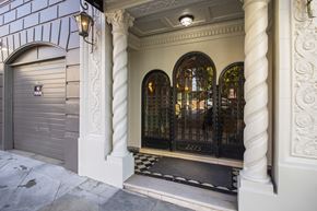San Francisco apartment for rent - A building with a closed grey door and a black gate.