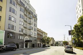 San Francisco apartment for rent - A street view of a residential area with cars parked on the side of the road.