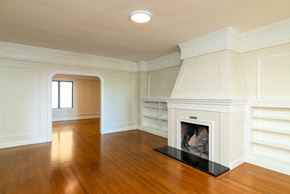San Francisco apartment for rent - A white fireplace in a room with wooden floors and white walls.