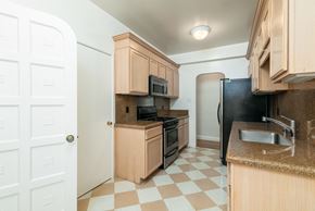 San Francisco apartment for rent - A kitchen with black appliances and wooden cabinets.