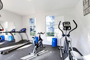 Aurora apartment for rent - a gym with treadmills and bikes in a room with windows