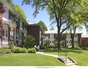 Paterson apartment for rent - a rendering of an apartment building with a lawn and trees