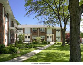 Paterson apartment for rent - a view of the front of a building with trees and grass