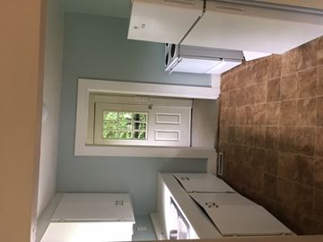 Talladega house for rent - a small kitchen with white appliances and a window