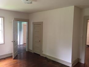 Talladega house for rent - an empty living room with white walls and a wood floor