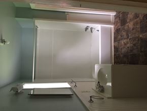 Talladega house for rent - a bathroom with a shower and a sink and a mirror