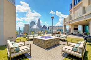 Charlotte apartment for rent - A patio with a pool table and chairs overlooking a city skyline.