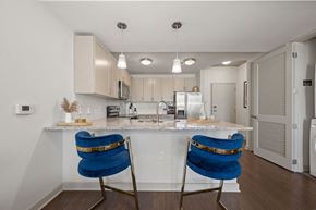 Charlotte apartment for rent - A kitchen with a white counter top and blue chairs.