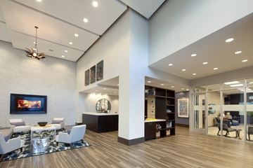 Charlotte apartment for rent - A modern living room with a white couch and a painting on the wall.