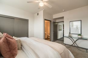 Plano apartment for rent - a bedroom with a large bed and a ceiling fan