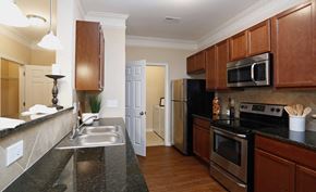 Garner apartment for rent - a kitchen with stainless steel appliances and granite counter tops