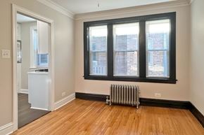 Oak Park apartment for rent - A room with a window, a radiator, and a wooden floor.