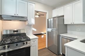 Oak Park apartment for rent - A kitchen with a stove, refrigerator, and cabinets.
