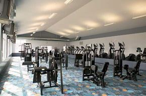 Omaha apartment for rent - a gym with rows of exercise equipment and chairs