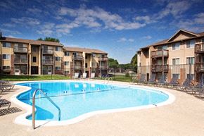 Omaha apartment for rent - a large swimming pool in front of an apartment building