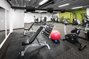 Omaha apartment for rent - a gym with weights and other exercise equipment on the floor