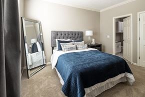 Lavista apartment for rent - A bedroom with a large bed and a mirror on the wall.