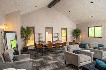 Omaha apartment for rent - a large living room with couches and chairs and a dining table