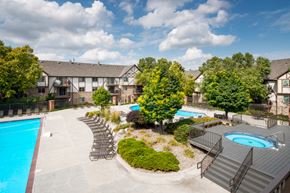 Omaha apartment for rent - an aerial view of a swimming pool and patio with chairs and trees